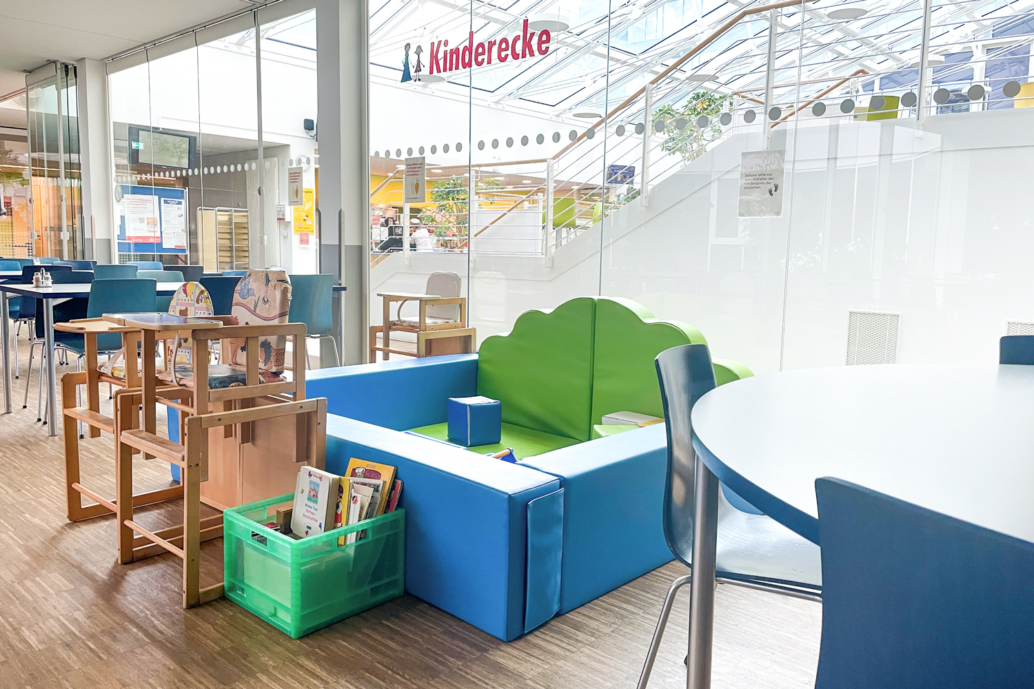 Die Kinderecke in einem abgetrennten Bereich mit Schaumstoffwänden, Büchern und verschiedenen Spielzeugen.
